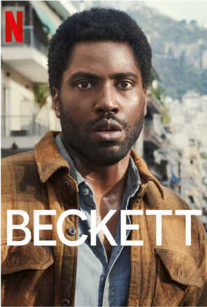 John David Washington looking confused in front of greek city